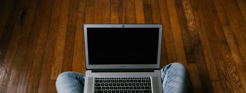 person working on laptop in dark