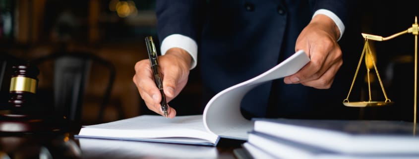 Close up lawyer businessman working or reading lawbook in office workplace for consultant lawyer concept.