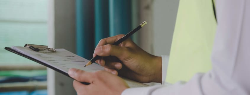 Man holding a pen and paper