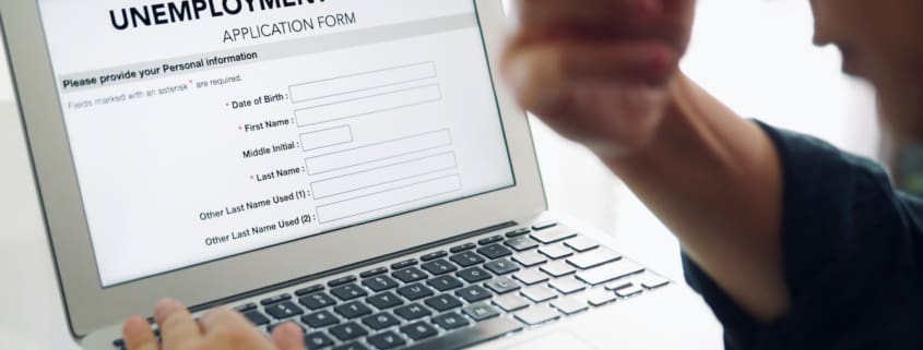 depressed person filling out an online unemployment benefits application form