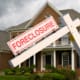 Foreclosure sign in front on modern house