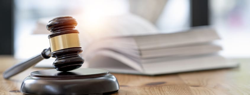 Wooden brown judge gavel on the table, copy space, banner background.