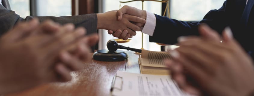 Business team and lawyer shaking hand after discussing about agreement contract. Law, legal services, advice, Justice concept.