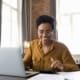 Woman smiling using a laptop