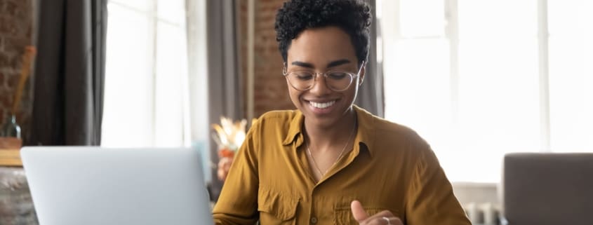 Woman smiling using a laptop