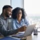 Man and woman looking at a laptop