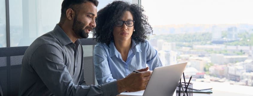 Man and woman looking at a laptop