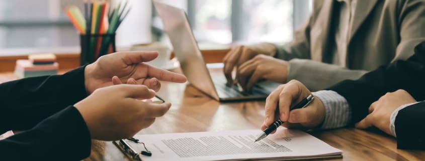 Woman about to sign a document