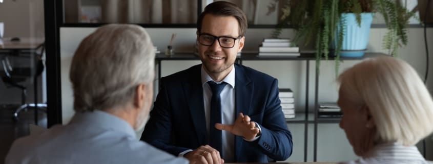 Man talking to an old couple