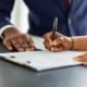 A woman signing a document