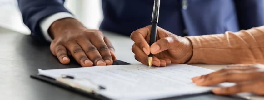 A woman signing a document