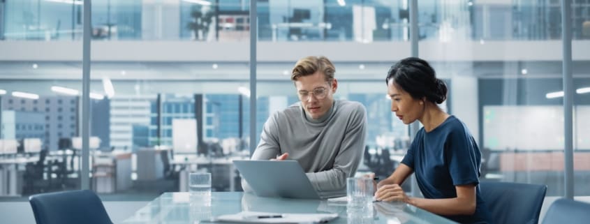 Man and a woman looking at a laptop